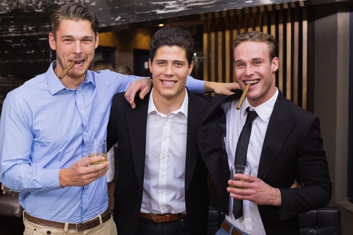 Group of businessmen enjoying drinks and cigars at a corporate event in Las Vegas, showcasing a VIP experience Group of businessmen enjoying drinks and cigars at a corporate event in Las Vegas, showcasing a VIP experience